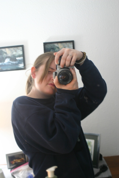 Casie taking a pictures of herself in a mirror with a SLR camera